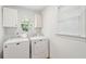 Clean laundry room featuring white cabinets, an oval window, and a washer and dryer for convenient laundry chores at 679 Clearview Dr, Charleston, SC 29412