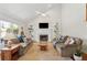 Inviting living room with vaulted ceiling, a cozy fireplace, built-in shelving, and hardwood floors at 679 Clearview Dr, Charleston, SC 29412