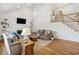 Bright living room features hardwood floors, a fireplace, built-in shelving, and stairs to the second floor at 679 Clearview Dr, Charleston, SC 29412