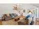 Spacious and naturally-lit living room with hardwood floors, comfortable seating, and a seamless flow to the kitchen at 679 Clearview Dr, Charleston, SC 29412