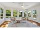 Relaxing sunroom featuring hardwood floors, natural light from the many surrounding windows, and an exterior door at 679 Clearview Dr, Charleston, SC 29412