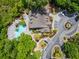 Stunning aerial view of the pool, clubhouse, and surrounding landscaping with mature trees and winding pathways at 700 Daniel Ellis Dr # 4104, Charleston, SC 29412