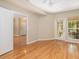 Sunlit bedroom with hardwood floors, ceiling fan, and access to patio at 700 Daniel Ellis Dr # 4104, Charleston, SC 29412