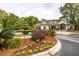 Beautiful clubhouse featuring lush landscaping with a tiered fountain, colorful flower beds, and manicured greenery at 700 Daniel Ellis Dr # 4104, Charleston, SC 29412