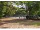 Secluded tennis court surrounded by lush greenery and mature trees, offering a private and peaceful recreational space at 700 Daniel Ellis Dr # 4104, Charleston, SC 29412