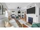 Cozy living room with a fireplace, flat screen TV, hardwood floors, and neutral colored furniture at 71 Cypress St, Charleston, SC 29403