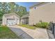 This backyard includes a detached garage, seating area, screened in porch, and tasteful landscaping at 7414 Purser Ln, Hanahan, SC 29410