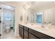 Bathroom with a double sink vanity, a large mirror, and tile floors plus a view to the toilet at 7414 Purser Ln, Hanahan, SC 29410