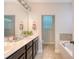Elegant bathroom featuring double vanity, white countertops, and a separate tub at 7414 Purser Ln, Hanahan, SC 29410