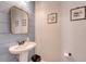Stylish powder room with blue shiplap accent wall, modern mirror, and tasteful decor creates an inviting space at 7414 Purser Ln, Hanahan, SC 29410