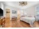 Bright bedroom featuring hardwood floors, ceiling fan, and ensuite bathroom access at 7414 Purser Ln, Hanahan, SC 29410