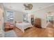 Cozy bedroom showcases hardwood floors, a ceiling fan, and a vintage pink chair at 7414 Purser Ln, Hanahan, SC 29410
