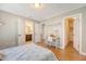 Bright bedroom features light wood floors, a desk, and adjacent bathroom and walk-in closet at 7414 Purser Ln, Hanahan, SC 29410