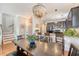 Open concept dining area showcasing an elegant chandelier and seamless transition into the modern kitchen at 7414 Purser Ln, Hanahan, SC 29410