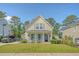 Charming two-story home featuring a well-manicured lawn and a welcoming front porch, exuding curb appeal in a serene neighborhood at 7414 Purser Ln, Hanahan, SC 29410