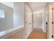 Upstairs hallway featuring light grey paint, wood floors, and a closet at 7414 Purser Ln, Hanahan, SC 29410