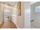 Hallway featuring hardwood floors and view into a bedroom at 7414 Purser Ln, Hanahan, SC 29410