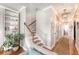 Hallway with staircase and built-in shelving, featuring a modern light fixture at 7414 Purser Ln, Hanahan, SC 29410