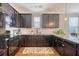 Efficient kitchen featuring stainless appliances, dark cabinets, and granite counters maximizes space for cooking at 7414 Purser Ln, Hanahan, SC 29410