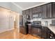 Functional kitchen features stainless appliances, dark cabinets, and granite counters, optimizing cooking space at 7414 Purser Ln, Hanahan, SC 29410