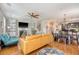 Spacious open-concept living space featuring hardwood floors, fireplace, and seamless flow to the dining area and kitchen at 7414 Purser Ln, Hanahan, SC 29410