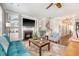 Inviting living room with a fireplace, built-in shelves, and hardwood floors, offering a perfect blend of comfort and style at 7414 Purser Ln, Hanahan, SC 29410