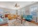 Bright and airy living room featuring hardwood floors, large windows, and stylish furnishings, creating a welcoming atmosphere at 7414 Purser Ln, Hanahan, SC 29410