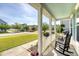 Relaxing front porch view showcasing a charming neighborhood street, complete with rocking chairs and blooming flower boxes at 7414 Purser Ln, Hanahan, SC 29410