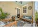 Outdoor porch with comfortable seating and a ceiling fan for comfort and a wreath on the wall at 7414 Purser Ln, Hanahan, SC 29410