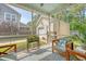Screened porch with comfortable seating and views of the backyard and garage at 7414 Purser Ln, Hanahan, SC 29410