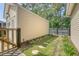 Yard with green grass, trees, and a privacy fence with a stepping stone pathway at 7414 Purser Ln, Hanahan, SC 29410