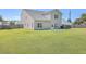 Well-maintained home exterior and large, level backyard featuring green grass and a fenced perimeter for added privacy and security at 7477 Painted Bunting Way, Hanahan, SC 29410