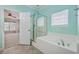 Clean bathroom featuring a glass-enclosed shower and tub with a window that brings in plenty of natural light at 7477 Painted Bunting Way, Hanahan, SC 29410