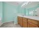 Bright bathroom with a large mirror, wood vanity, and excellent lighting, ideal for grooming at 7477 Painted Bunting Way, Hanahan, SC 29410