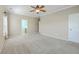 Open bedroom featuring neutral carpet, complemented by natural light and views into a connected bathroom at 7477 Painted Bunting Way, Hanahan, SC 29410