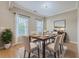 Bright dining room featuring hardwood floors, a wooden table, and stylish decor at 7477 Painted Bunting Way, Hanahan, SC 29410