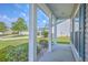 Inviting covered front porch with white columns and views of the well-maintained front yard and landscaping at 7477 Painted Bunting Way, Hanahan, SC 29410