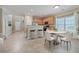 Eat-in kitchen features wooden cabinets, stainless steel appliances, and a round table with chairs at 7477 Painted Bunting Way, Hanahan, SC 29410