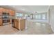 Open kitchen featuring wooden cabinets and stainless steel appliances; view into the living room at 7477 Painted Bunting Way, Hanahan, SC 29410