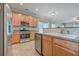 Kitchen features wood cabinets, stainless steel appliances, and tile backsplash at 7477 Painted Bunting Way, Hanahan, SC 29410