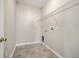 Functional laundry room featuring tiled floors, utility connections, and wire shelving for efficient organization at 7477 Painted Bunting Way, Hanahan, SC 29410