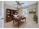 Comfortable home office featuring a desk, bookcase, neutral paint, ceiling fan, and a large window providing ample natural light at 7477 Painted Bunting Way, Hanahan, SC 29410
