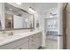 Bright bathroom featuring a double vanity with stone countertops, stylish bronze fixtures, and a view to the main bedroom at 81 Crossandra Ave, Summerville, SC 29483