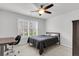 Bright bedroom featuring a ceiling fan, a bed, a desk with chair and window with white shutters at 81 Crossandra Ave, Summerville, SC 29483