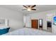 Bright bedroom with ceiling fan, dresser, and TV, leading to a walk-in closet at 81 Crossandra Ave, Summerville, SC 29483