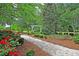 Path in a community park with benches, flowers, and trees at 81 Crossandra Ave, Summerville, SC 29483