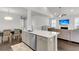 Open-concept kitchen and living area with hardwood floors and modern appliances at 81 Crossandra Ave, Summerville, SC 29483