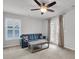 Cozy living room with a blue sofa, rustic coffee table, and double doors with curtains at 81 Crossandra Ave, Summerville, SC 29483