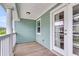 Covered porch featuring wooden floor and railing and green siding at 81 Crossandra Ave, Summerville, SC 29483