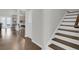 Hallway showcasing hardwood floors and a staircase leading to the upper level at 81 Crossandra Ave, Summerville, SC 29483